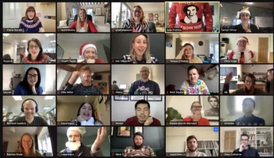 A screenshot of CXPartners zoom meeting where employees are wearing Christmas jumpers