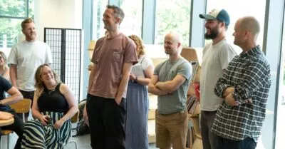 A photo of Stuart, smiling, standing with a small group of other cxpartners employees