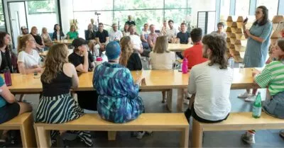 A photo of the cxpartners team sat around on tables at our summer conference