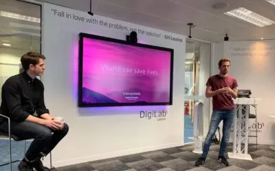 David presenting a slide that reads 'VR&MR can save lives' at DigiLab London
