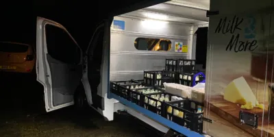 A milk van delivering milk at night